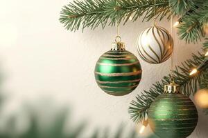three decorative spheres hang from a conifer branch. photo