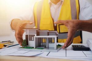 Architects, engineers, contractors working in the office with blueprints, inspection engineers Work analysis for architectural plan, construction project sketch, focus, business construction concept. photo