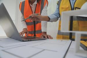 Construction and structure concept of Engineer or architect meeting for project working with partner and engineering tools on model building and blueprint in working site, contract for both companies. photo