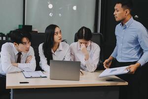 Frustrated upset multiracial business team people sad with bad work result in report disappointed in corporate bankruptcy failure crisis worried of paperwork problem sit at table at office meeting photo