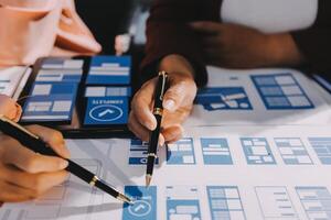 Young Asian business creative team work together, mobile application software design project. Brainstorm meeting, internet technology, smartphone web app designer, office coworker teamwork concept photo