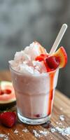 Refreshing strawberry slush with syrup and fresh fruit garnished on a wooden table photo