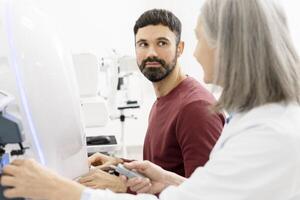 Ophthalmologist performing eyesight test with modern equipment photo
