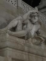 Detailed sculpture of a reclining figure with a beard and intricate draper photo