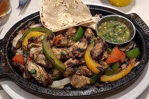 Delicious Chicken Fajitas with Peppers and Onions, Served with Warm Tortilla and Salsa photo
