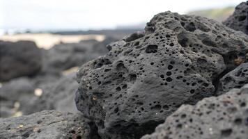 Rough Porous Texture of Black Volcanic Rock with Irregular Formations photo