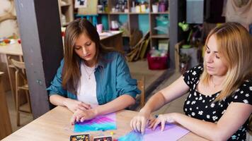 Creative art session with two women crafting at a studio in the afternoon video