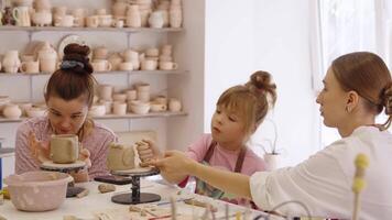 A pottery class with children and parents in a creative studio setting video