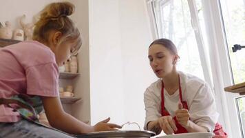 A creative pottery session with a child at an art studio in early spring video