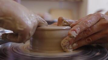Creating beautiful pottery on the wheel in a sunny studio setting video