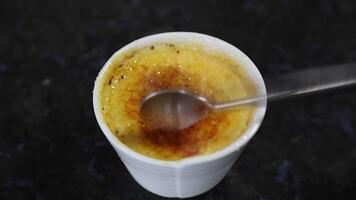 Creme brulee, creme brule. Classic creme brule being flambe. Burning, flaming, ramekins, vanilla beans, blowtorch, sugar video