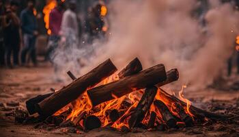 Campfire with Smoke and Blurry People in the Background photo