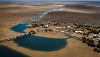 Aerial View of a Bridge Over a Winding River in a Desert Landscape photo