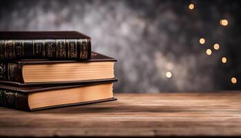 Stack of Books on Wooden Table with Blurred Lights photo