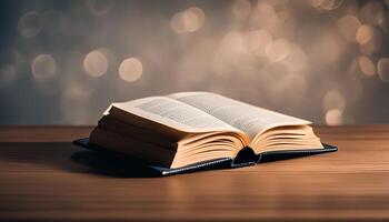 Open Book on Wooden Table with Bokeh Background photo