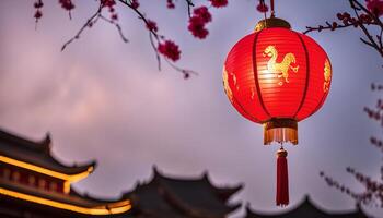 Red Chinese Lantern Hanging on a Tree Branch with a Blurred Temple in the Background photo
