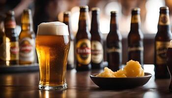 Beer Glass with Bottles and Snacks on a Bar Table photo