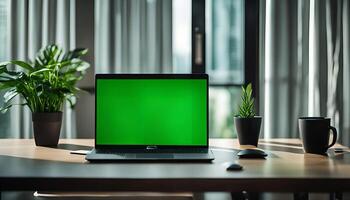 Laptop Computer with a Green Screen on a Desk photo