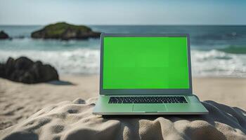 Laptop on a Beach with Green Screen photo