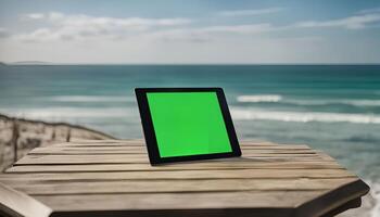 Tablet on a wooden table with a sea view photo