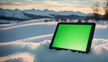 Tablet in a Snowy Mountain Landscape photo