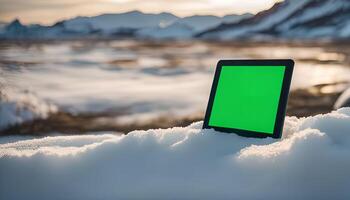 Tablet in Snow with Mountain Landscape photo
