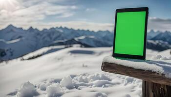 Tablet on snowy mountain peak photo