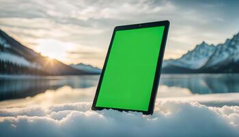 Tablet on snowy mountain landscape photo