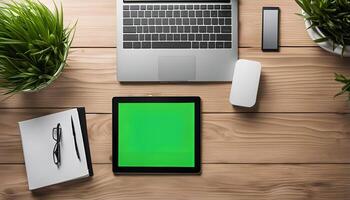 Top View of a Desk with Electronics and Plants photo