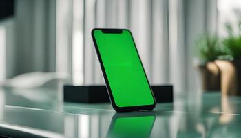 Smartphone with Green Screen on a Glass Table photo