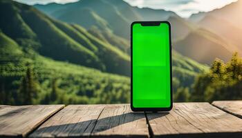 Smartphone with Green Screen in Front of Mountain View photo