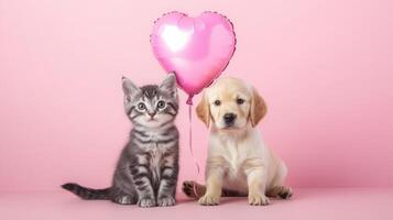 A playful kitten and a friendly puppy sit side by side on a soft surface, with a shiny heart-shaped balloon floating above them. The pastel pink backdrop enhances their adorable appearance. photo