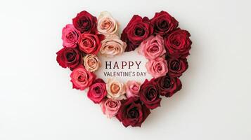 A beautiful heart-shaped arrangement of red, pink, and cream roses displays an affectionate message. The vibrant flowers are set against a simple white background, perfect for Valentine's Day. photo