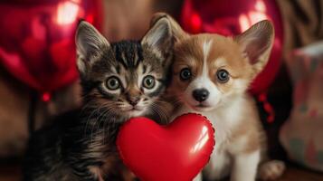 A playful kitten and an adorable corgi puppy are posing together, holding a red heart toy. Red balloons float in the background, adding a festive touch to the joyful atmosphere. photo