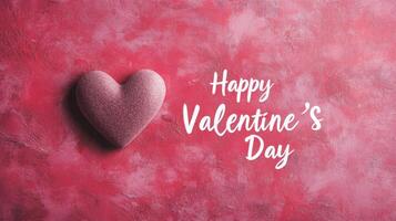 A soft pink heart rests on a textured pink surface, accompanied by the phrase Happy Valentine's Day in elegant script. This setting captures the spirit of love and affection. photo