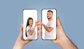 A couple expresses their love and connection by chatting through smartphones. Their hands reach out toward each other, showcasing their bond despite the digital barrier of a screen. photo