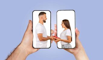 Two individuals connect through their smartphones, exchanging gifts and messages. The hands hold the phones, showcasing their loving interaction and modern communication. photo