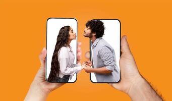 A couple engages in a loving interaction, holding hands and communicating through smartphones. They appear to be sharing a special moment while using a chat application. photo