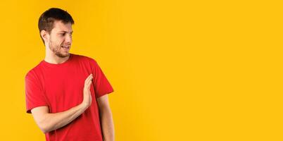 Eww, Expression Of Disgust. Portrait of irritated bearded man holding hand for rejection, showing stop gesture with palm aside to copy space, posing isolated over blue background, banner, panorama photo