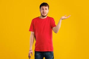 Who Knows. Portrait Of Funny Confused Man Shrugging Shoulders With Tipping Hand, Looking At Camera Posing Over Blue Background. Studio Shot. Puzzled guy is clueless. I'm sorry, exuse me, can't decide photo