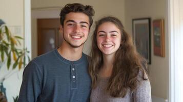 A young couple stands closely together, smiling warmly, in a comfortable indoor setting. Natural light fills the room, highlighting their happy expressions and relaxed atmosphere. photo