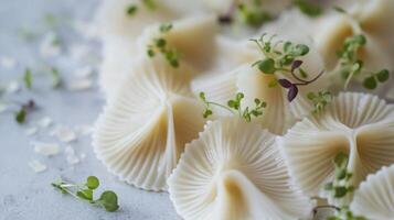 A vibrant display of freshly made pasta shaped into unique forms is complemented by delicate herbs. This delightful dish showcases culinary creativity during a sunny kitchen afternoon. photo