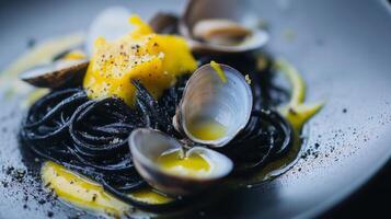 This dish features black pasta elegantly twirled on a plate, garnished with fresh clams and a rich, velvety sauce. The vibrant colors enhance its gourmet appearance, perfect for fine dining. photo