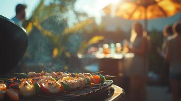 Skewers loaded with colorful vegetables and shrimp sizzle on a grill at an outdoor gathering. The sun sets, casting a warm glow over guests enjoying drinks and lively conversation. photo
