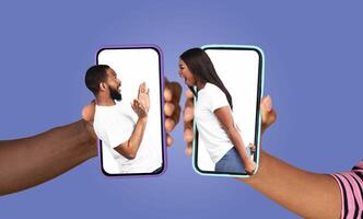A couple uses their smartphones to connect, sharing joyful moments through text messages. Their enthusiastic expressions capture the essence of modern love and communication. photo