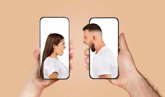 A couple appears on separate smartphones, each expressing strong emotions while chatting. Their hands hold the devices closely, showcasing intense feelings through the screen. photo