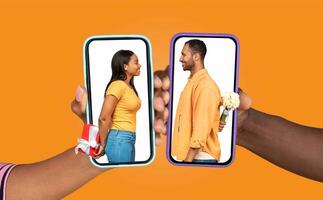 Two people are joyfully connecting through smartphones, exchanging messages. One holds a gift while the other conceals flowers, symbolizing romance and connection. photo