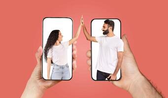 A couple engages in a loving interaction using their smartphones. They are smiling and reaching towards each other from their screens, showcasing the power of technology in connecting hearts. photo