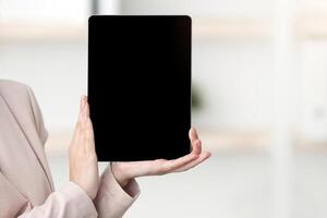 Tour Agent In Face Mask Showing Empty Digital Tablet Screen To Black Tourists Couple Offering Family Vacation Sitting In Modern Office. Touristic Agency Services And Offers. Selective Focus, Mockup photo