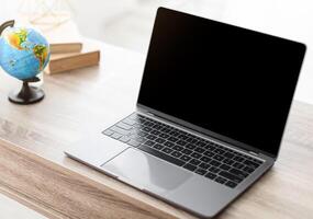 Unrecognizable Female Travel Agent Using Laptop With Empty Screen Making Call Sitting At Desk In Tour Agency Office. Online Consultation, E-Teaching. Selective Focus, Mockup photo